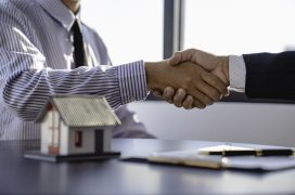 real estate businesspeople shaking hands in office for business merger teamwork successful negotiations handshake and business agreement concept.